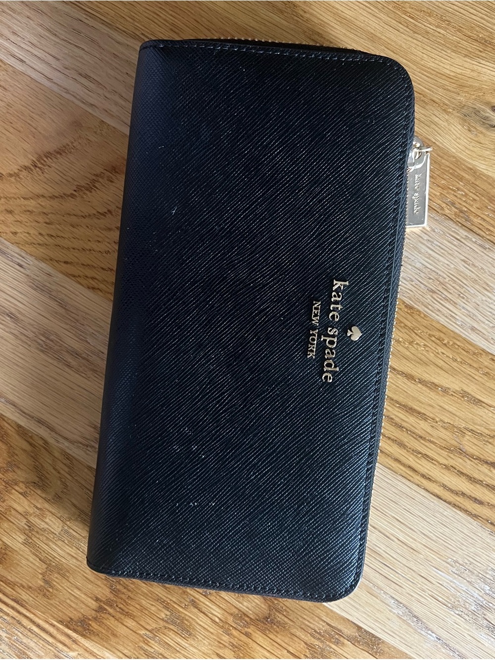 kate spade black zip-around saffiano wallet with gold logo